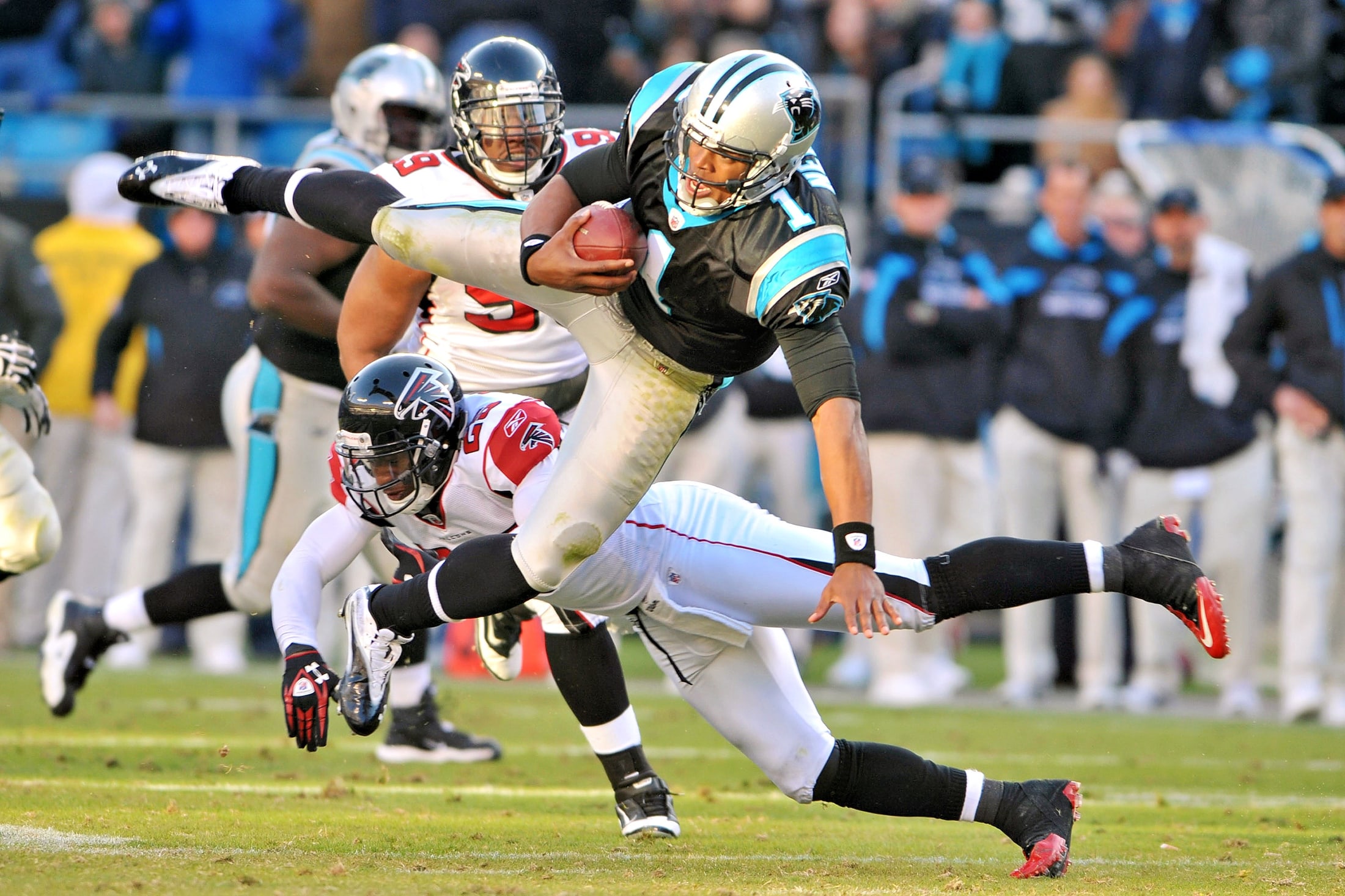 Football action image with an athlete breaking through contact